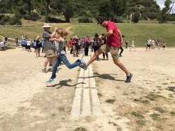 crossing the finish line in ancient Olympian stadium
