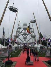 "Dinner in the Sky" tables hoisted on cranes in front of the Atomium